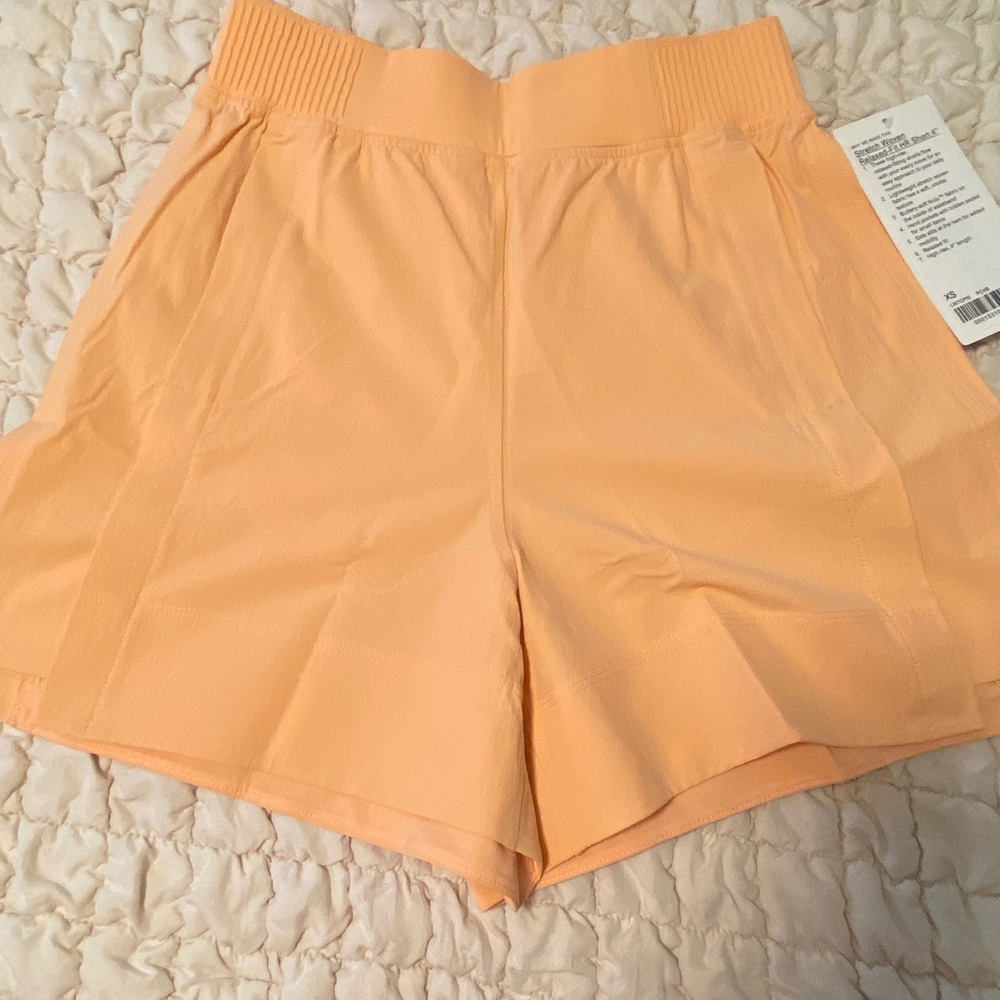 Lululemon stretch woven relaxed fit shorts peach Bellini color